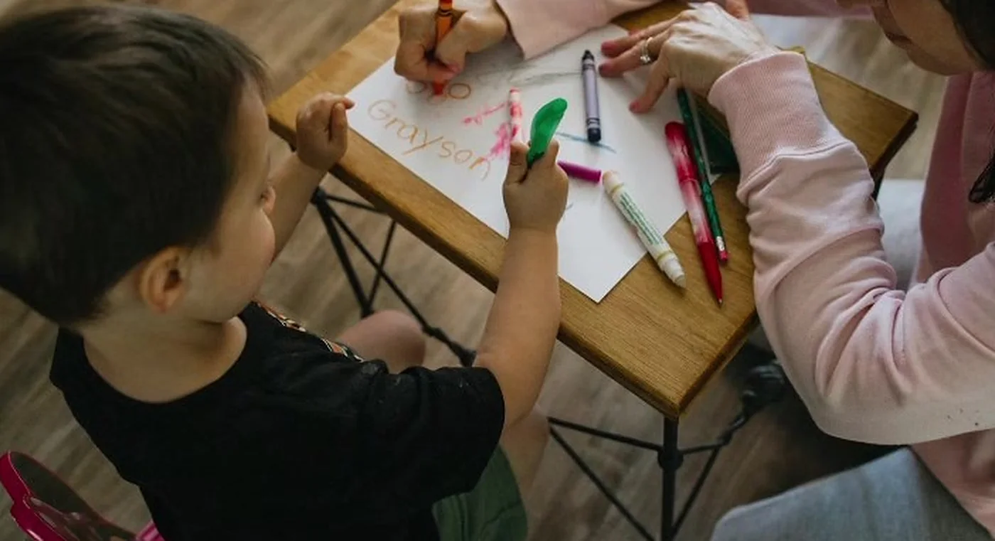 Special educator guiding a child through a learning activity